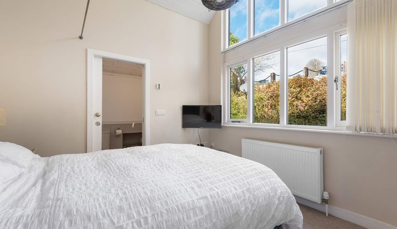 The magnificent, large window floods the room with natural light.