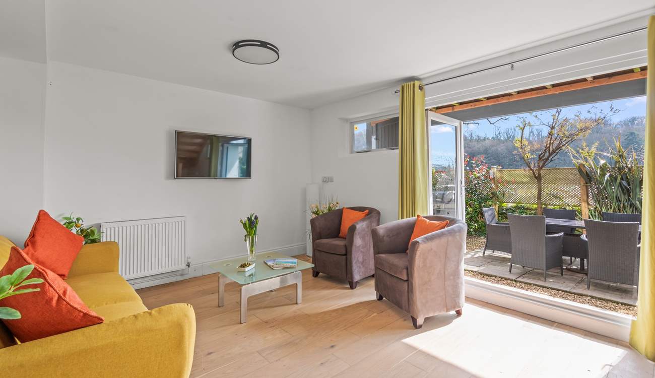 The space comes equipped with another Smart TV and sliding doors to the garden.