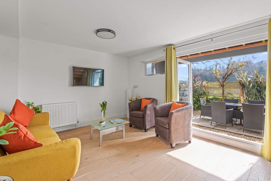 The space comes equipped with another Smart TV and sliding doors to the garden.