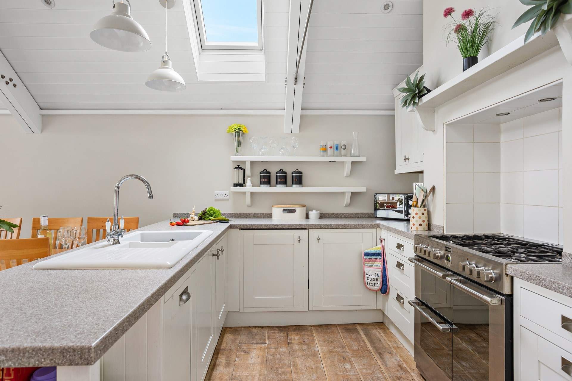 A crisp modern kitchen sits at the end of the space.