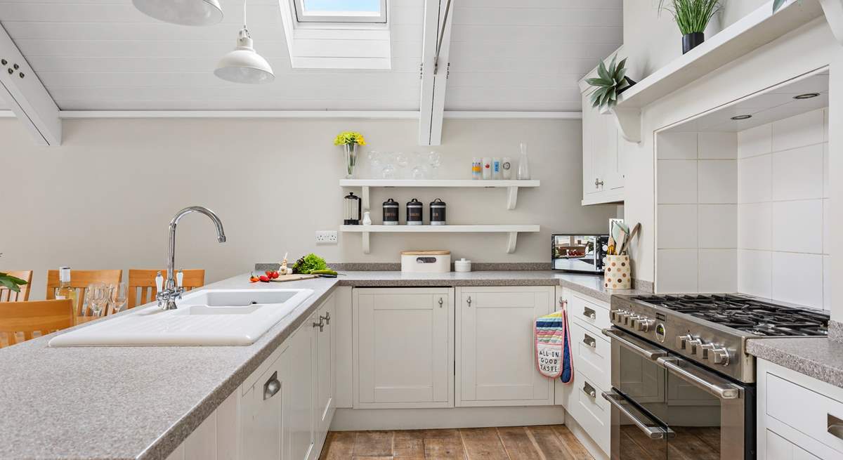 A crisp modern kitchen sits at the end of the space.