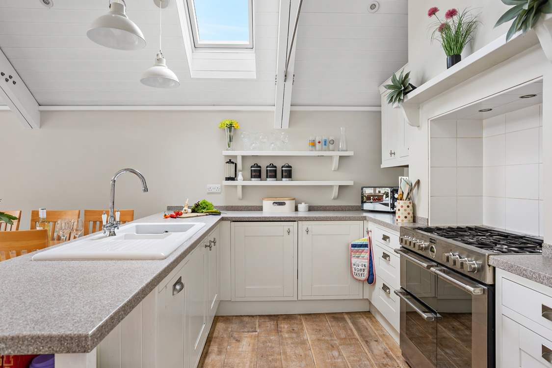A crisp modern kitchen sits at the end of the space.