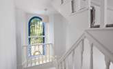 The beautiful stained glass window and stairs which lead to the second floor. - Thumbnail Image