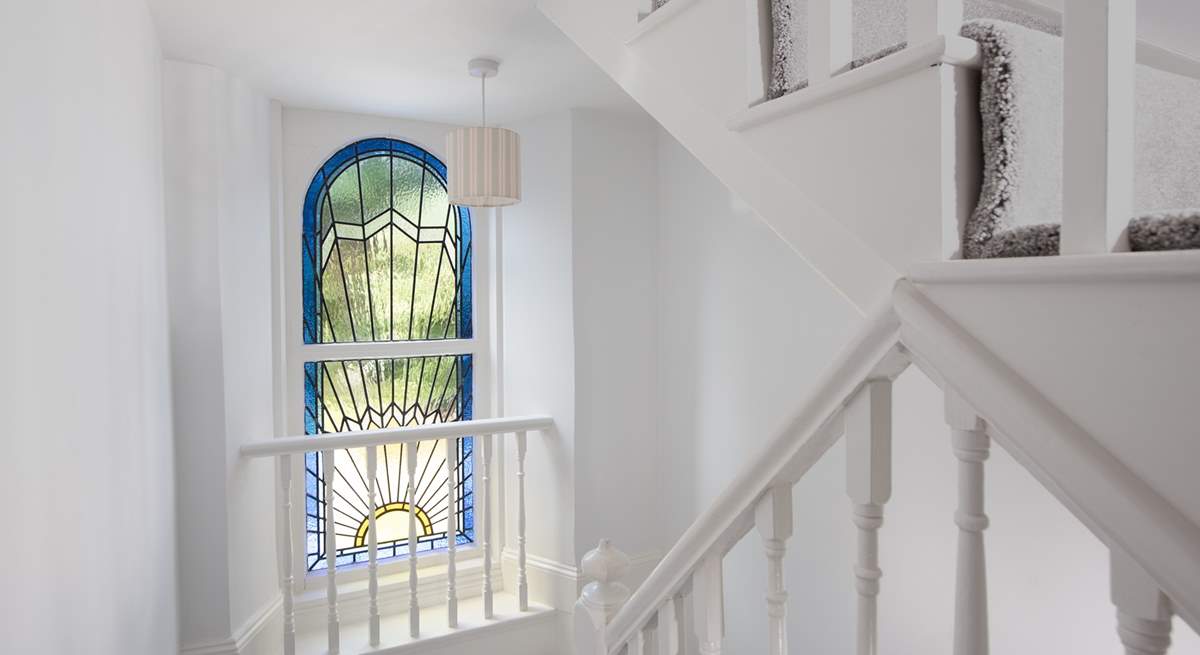 The beautiful stained glass window and stairs which lead to the second floor.