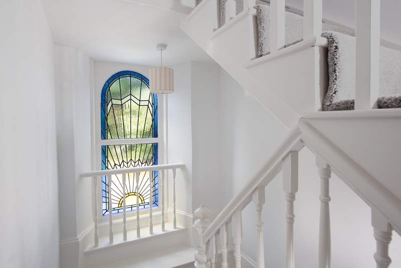 The beautiful stained glass window and stairs which lead to the second floor.
