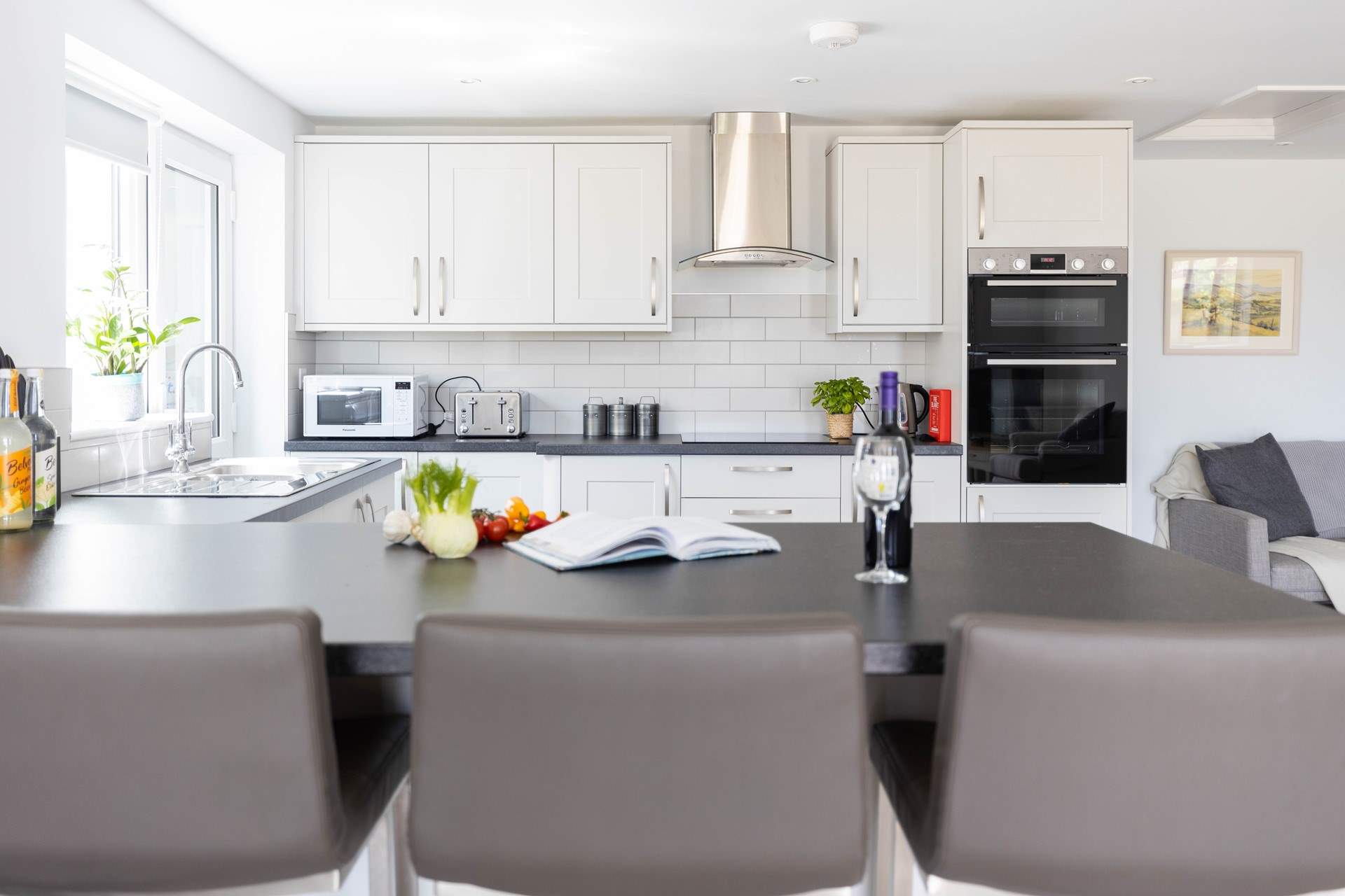 Sit at the breakfast-bar and supervise the chef.