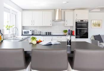 Sit at the breakfast-bar and supervise the chef.