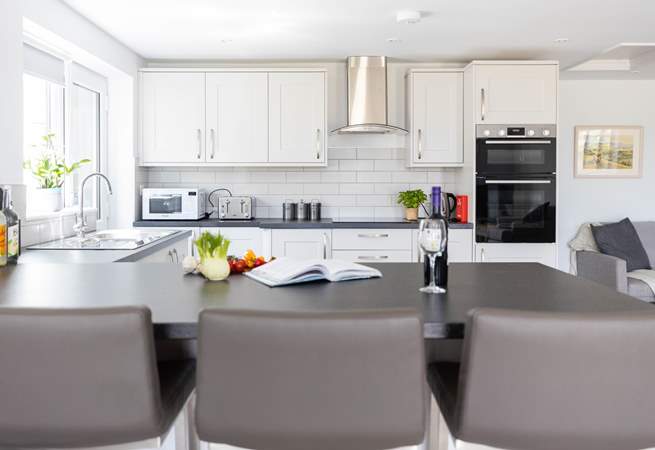 Sit at the breakfast-bar and supervise the chef.