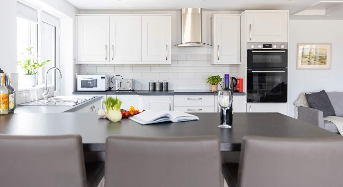 Sit at the breakfast-bar and supervise the chef.