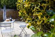 There's a secluded patio at the rear of The Wickets with a bistro table and chairs.