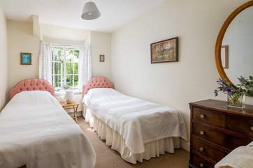 Natural light floods into charming bedroom two.