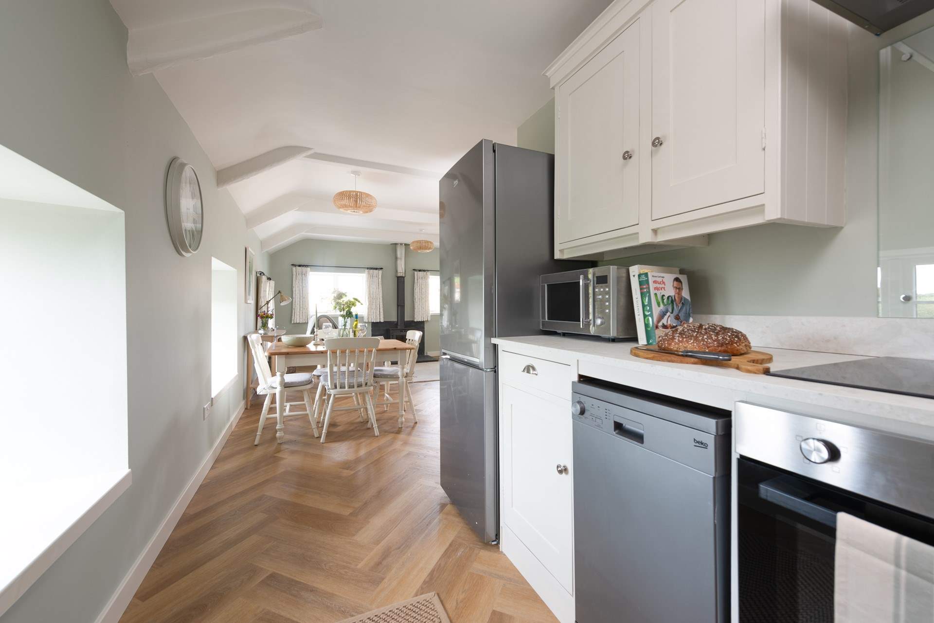 A modern kitchen can be found at the rear of the living area.