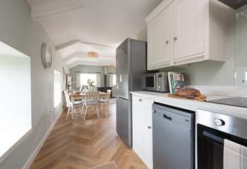 A modern kitchen can be found at the rear of the living area.