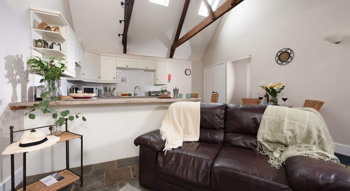 All on one floor, the living space is light and bright with dual-height ceilings and exposed characterful beams.