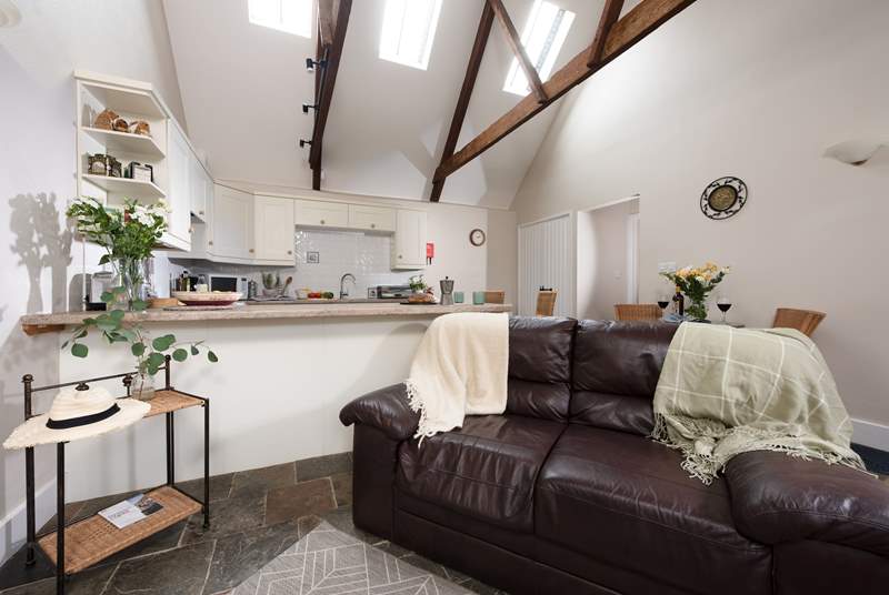 All on one floor, the living space is light and bright with dual-height ceilings and exposed characterful beams.