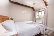The pretty double bedroom has a king-size bed.