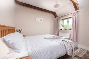 The pretty double bedroom has a king-size bed.