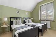 Bedroom 2 is a cute room with twin beds.
