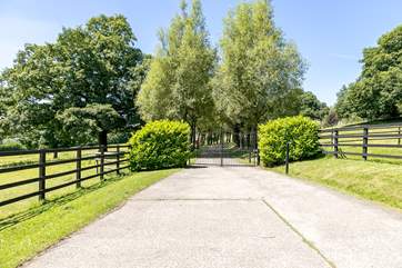 The front gates lead down to drive to the estate.