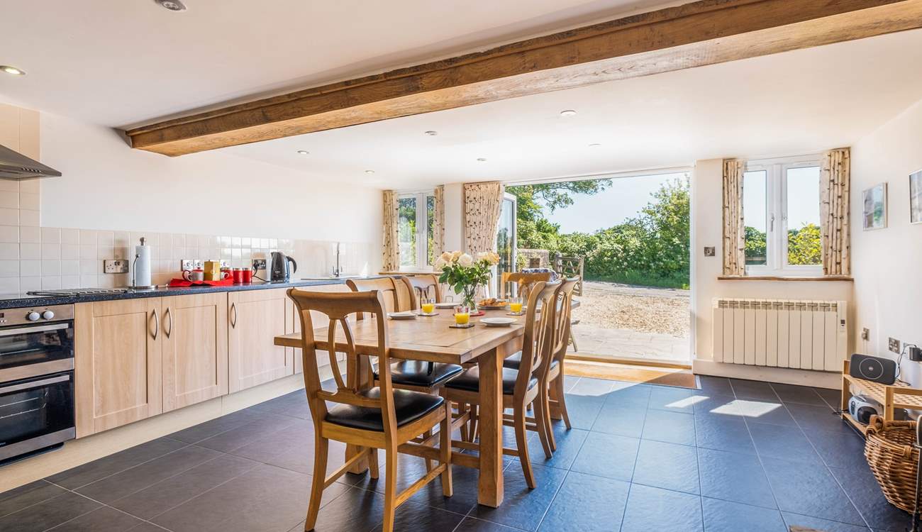 The spacious and sociable kitchen has bi-folding doors that open onto the patio and courtyard.