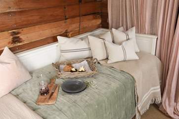 The day bed is an idyllic spot to unwind with a good book and a treat or two.