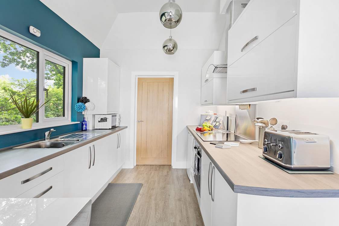 The modern kitchen has everything you'll need, with the door leading through to the utility room.