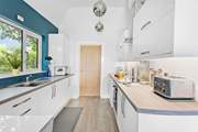 The modern kitchen has everything you'll need, with the door leading through to the utility room.