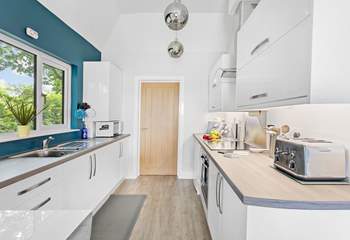 The modern kitchen has everything you'll need, with the door leading through to the utility room.