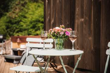 Enjoy a glass of your favourite before taking a dip in the bubbling hot tub.
