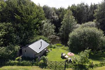 The main cabin overlooks an idyllic pond.