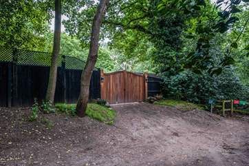 Gates to a secure parking area and the entrance to Hideaway Heath Hollow.