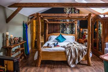 The fabulous wooden king-size four-poster bed promises a restful night's sleep.