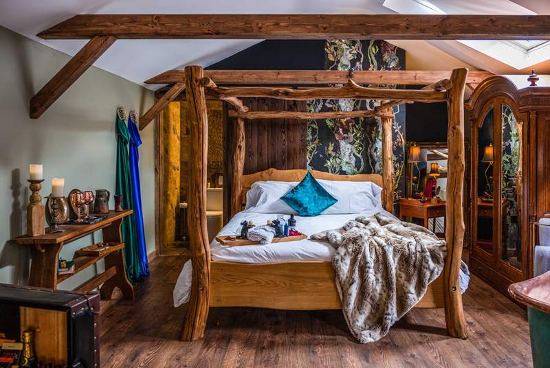 The fabulous wooden king-size four-poster bed promises a restful night's sleep.