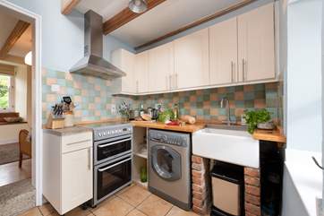 The kitchen is off the sitting-room and separated by a curtain.