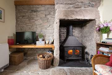 Cosy up in front of the wood-burner which sits in a feature granite fireplace.