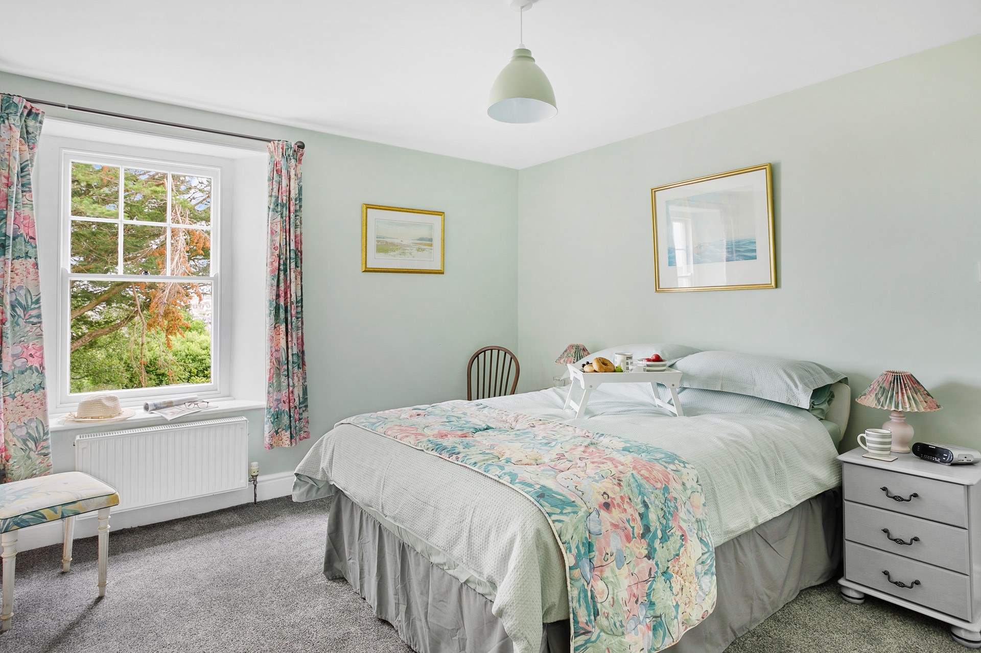 The pretty double bedroom has a lovely outlook towards the river.