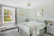The pretty double bedroom has a lovely outlook towards the river.