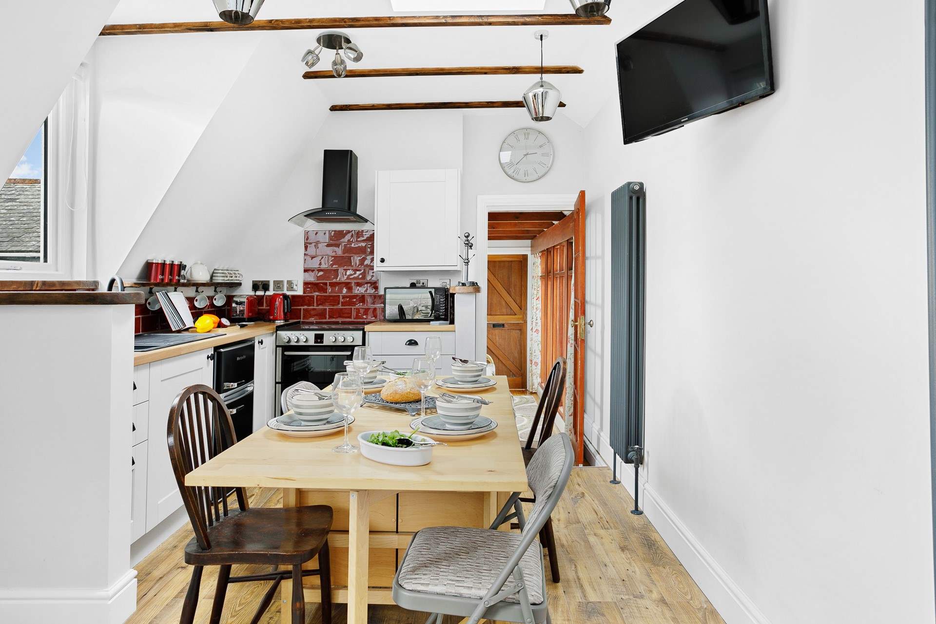 The convenient table can be set up at meal times and then tucked out of the way in between.