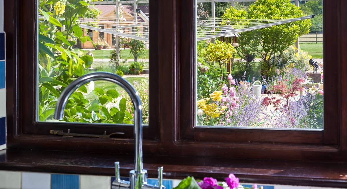 Gaze out the kitchen window to the owners' beautiful garden, which is filled with colourful flowers.