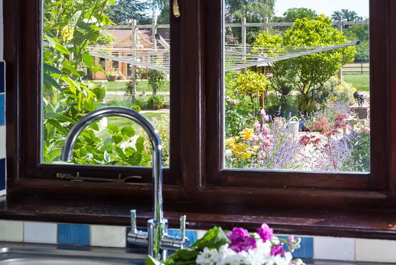 Gaze out the kitchen window to the owners' beautiful garden, which is filled with colourful flowers.