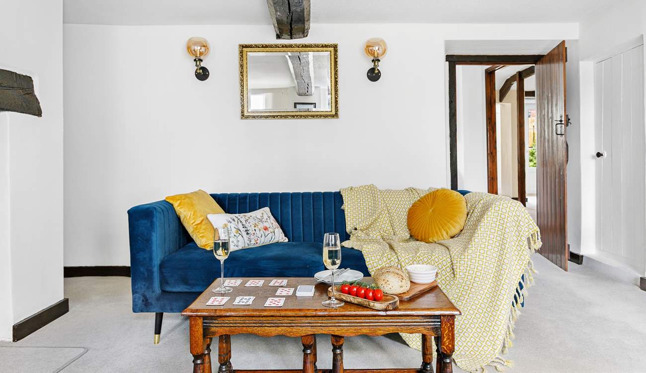 Snuggle up in front of the fire on the lavish velvet sofas, the kitchen and dining-room are accessed through the door to the right.