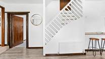 Stairs from the kitchen leading up to bedroom 5.
