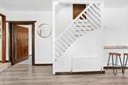Stairs from the kitchen leading up to bedroom five.