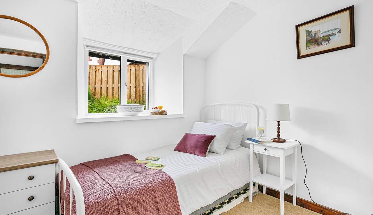 A delightful single bed is accompanied by a handy trundle bed in bedroom one.