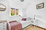 A delightful single bed is accompanied by a handy trundle bed in bedroom one.