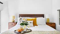 A gorgeous double bed sits in the centre of bedroom 6.