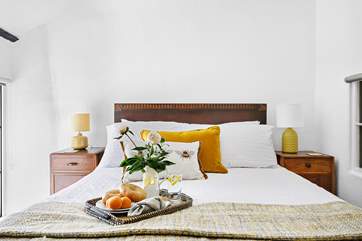 A gorgeous double bed sits in the centre of bedroom six.