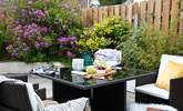 The patio at the rear of the house is perfect for al fresco dining. - Thumbnail Image