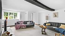 A gorgeous wooden beam runs across the second sitting-room's ceiling.
