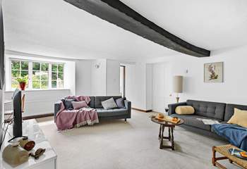 A gorgeous wooden beam runs across the second sitting-room's ceiling.